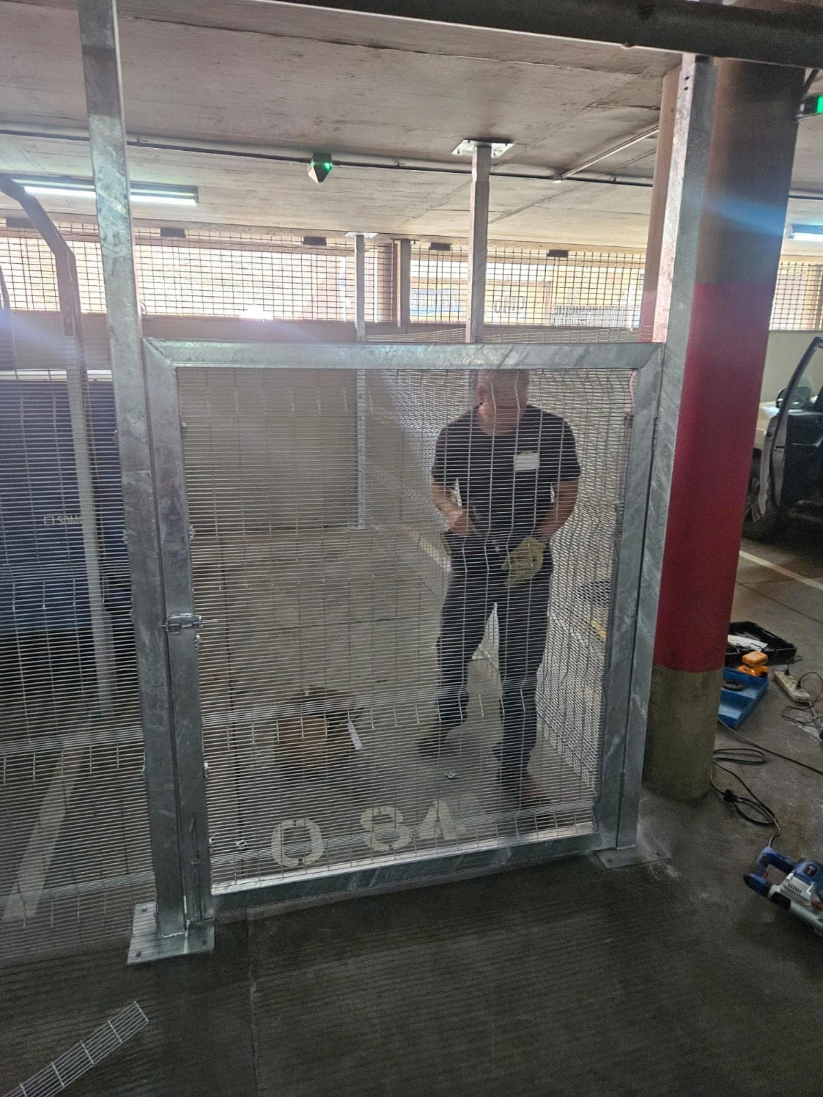 Lockable storage cage with pedestrian gate