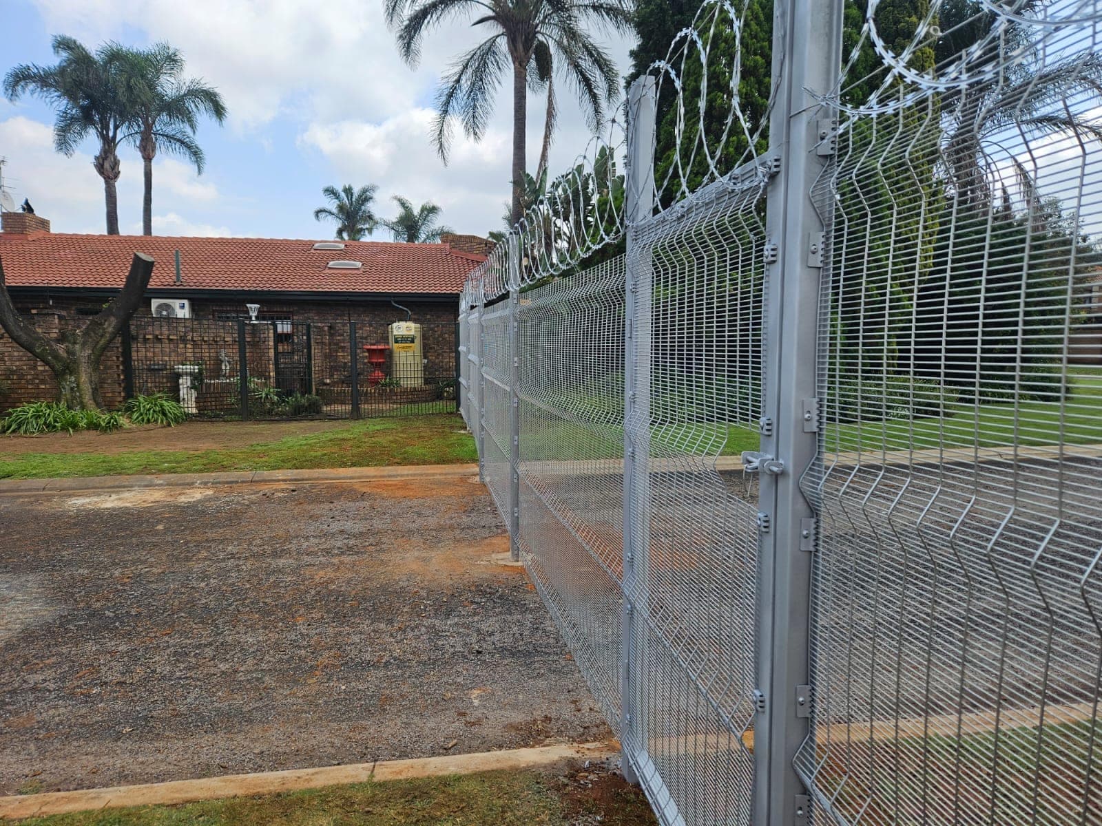 Street-front perimeter with razor topping