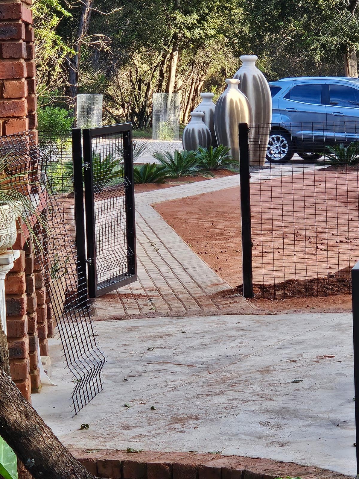 Black mesh garden gate and boundary