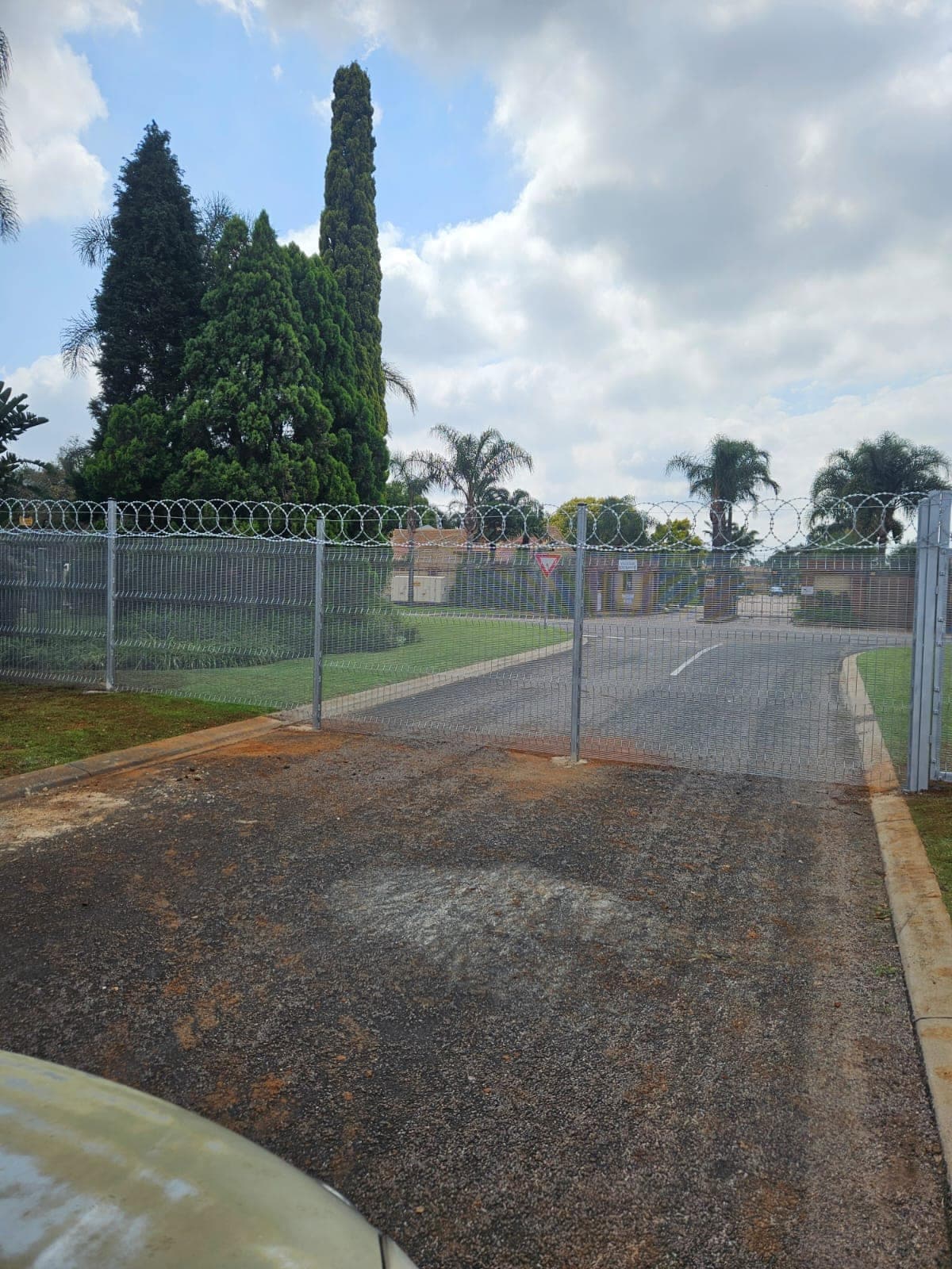 Driveway gate with razor-wire line